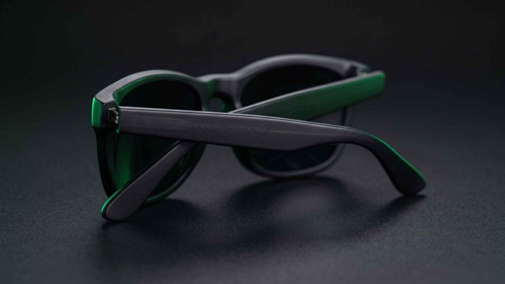 Close-up of folded sunglasses showing the inside of the temple arm where the model number is engraved