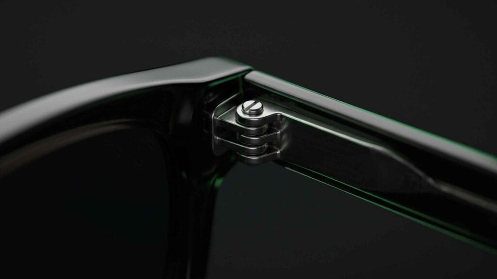 Extreme close-up of a sunglasses screw hinge with interleaved metal barrels
