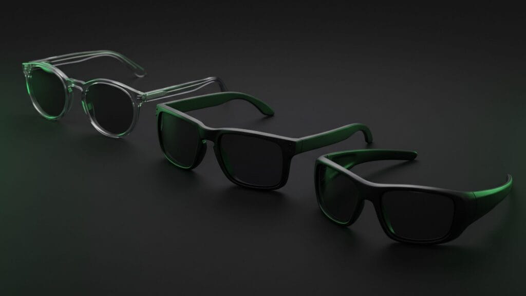 Three sport sunglasses frames of different shapes lined up on a dark background
